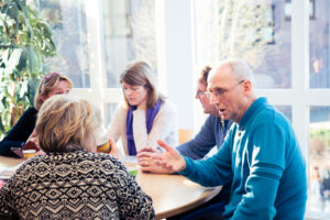 Een groep mensen die op het mbo met seksualiteit te maken hebben, zitten rond een tafel. School en Veiligheid